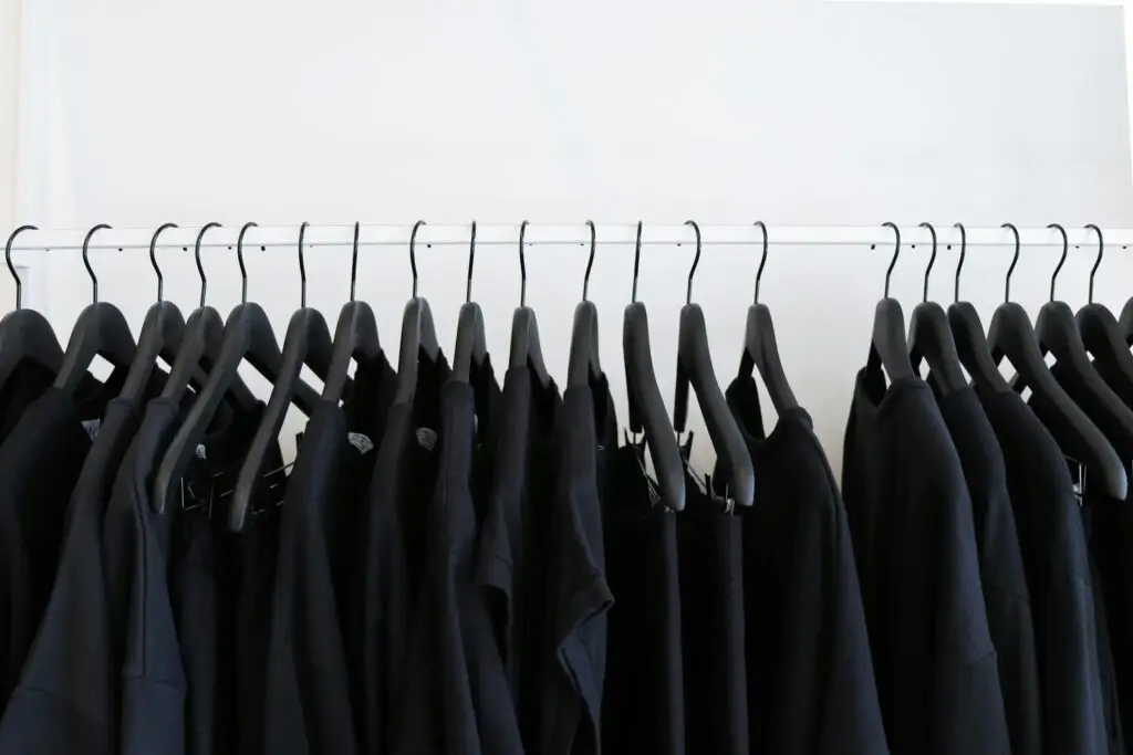 Black T shirts and sweaters in hangers